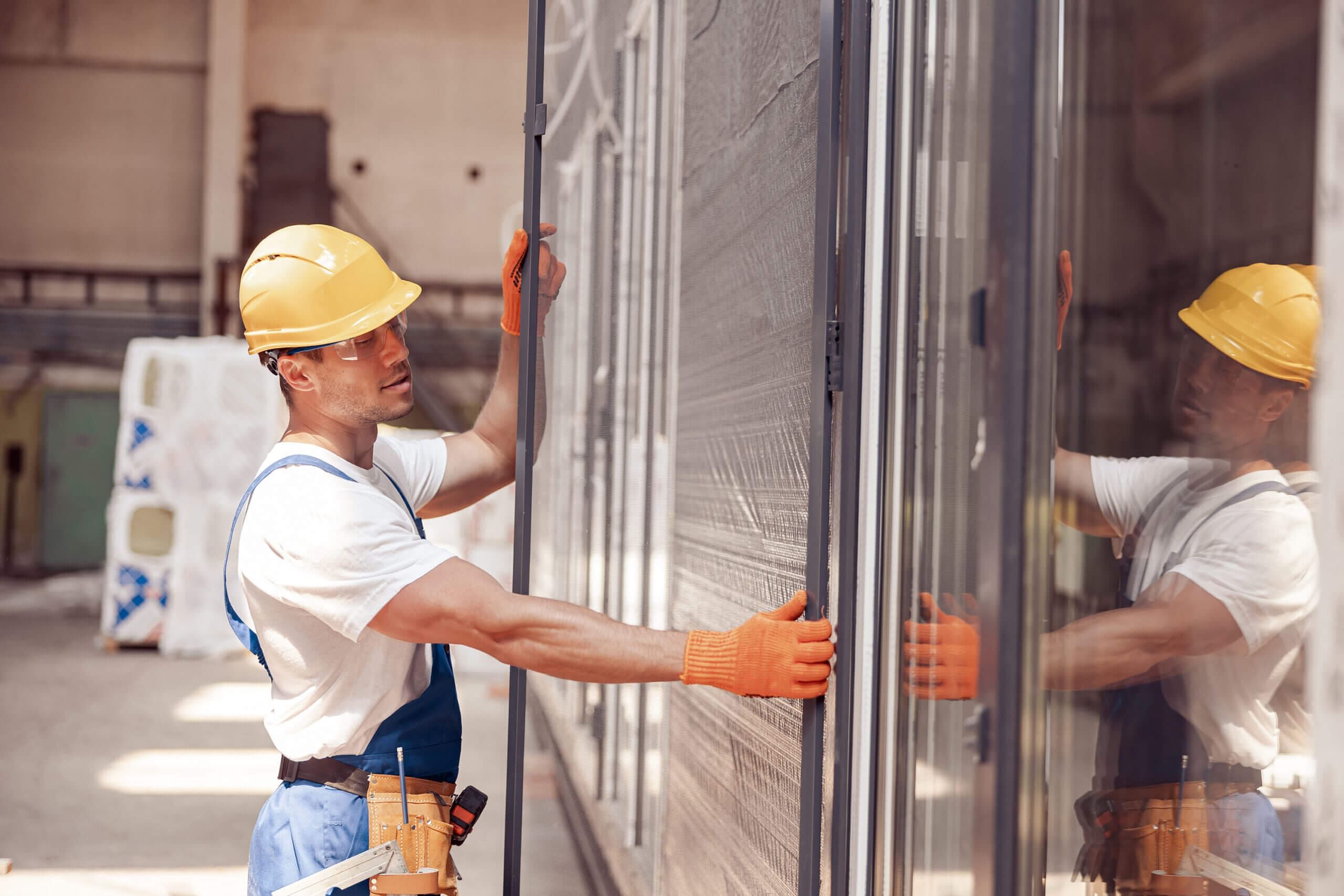 A man installing the Sliding Glass Door